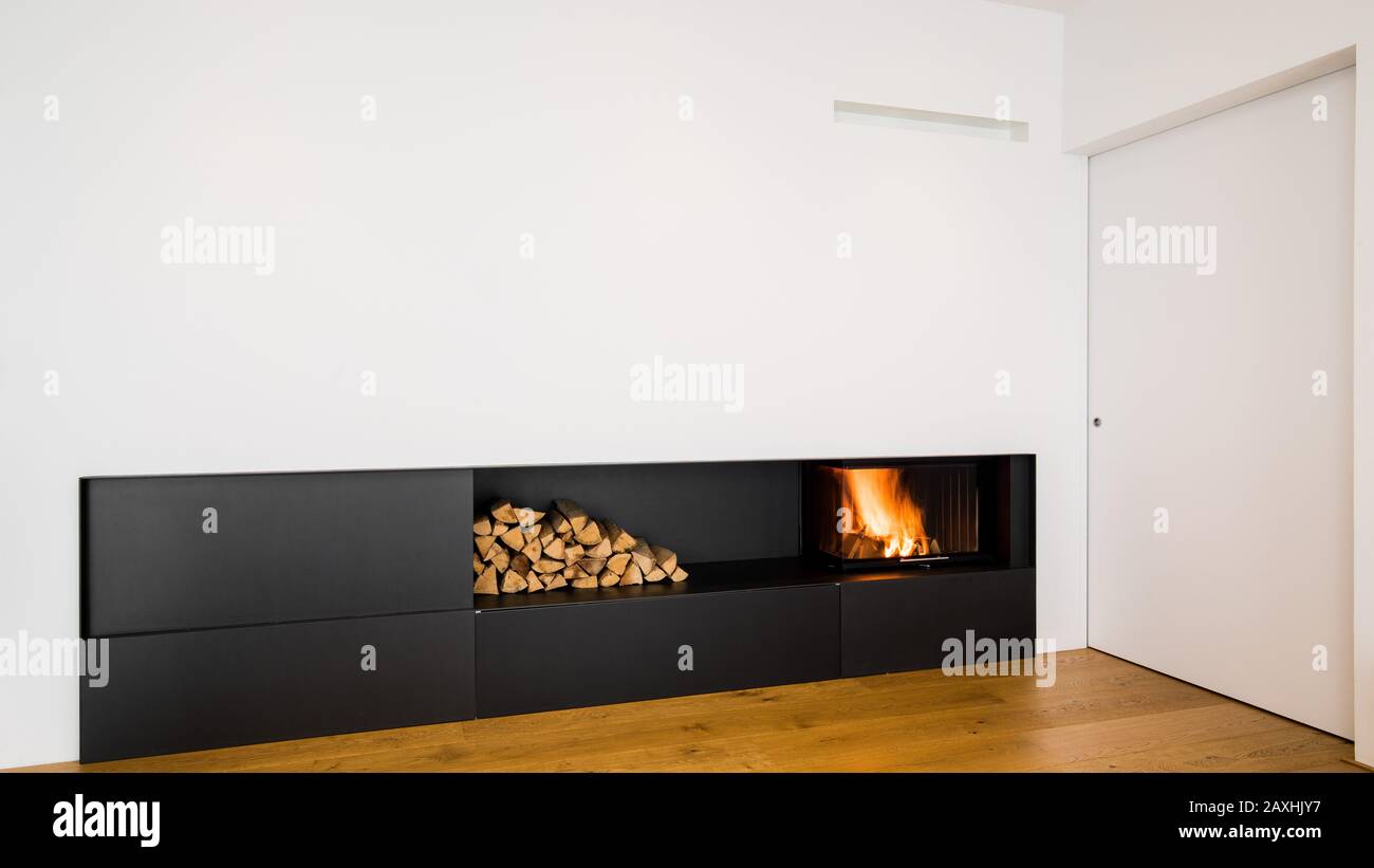 modern, minimalist fireplace at the entrance to the room Stock Photo