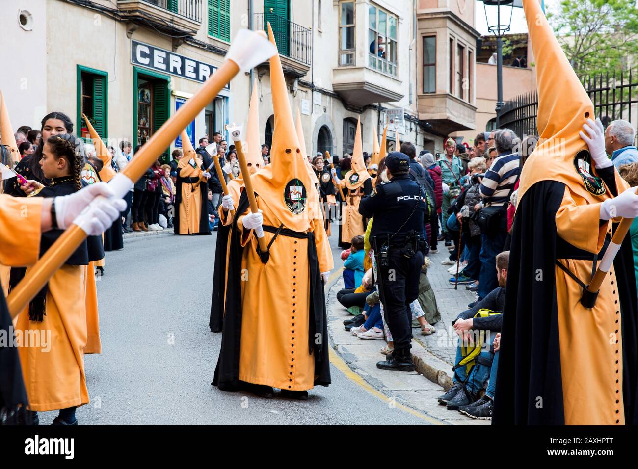 Holy Thursday procession of church brotherhood penitents in conical hoods and robes of different colours carrying religious statues Stock Photo