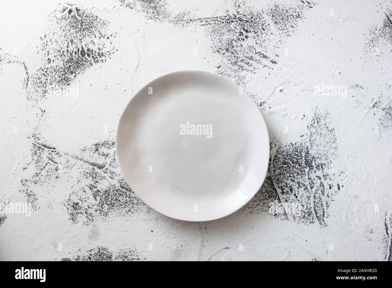 Round Plate on white abstract scraped wooden table background Stock Photo