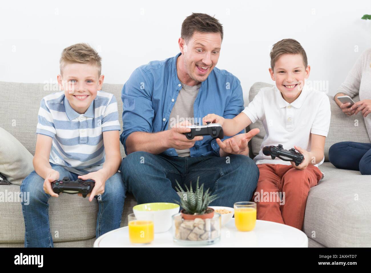 Happy young family playing videogame On TV. Stock Photo