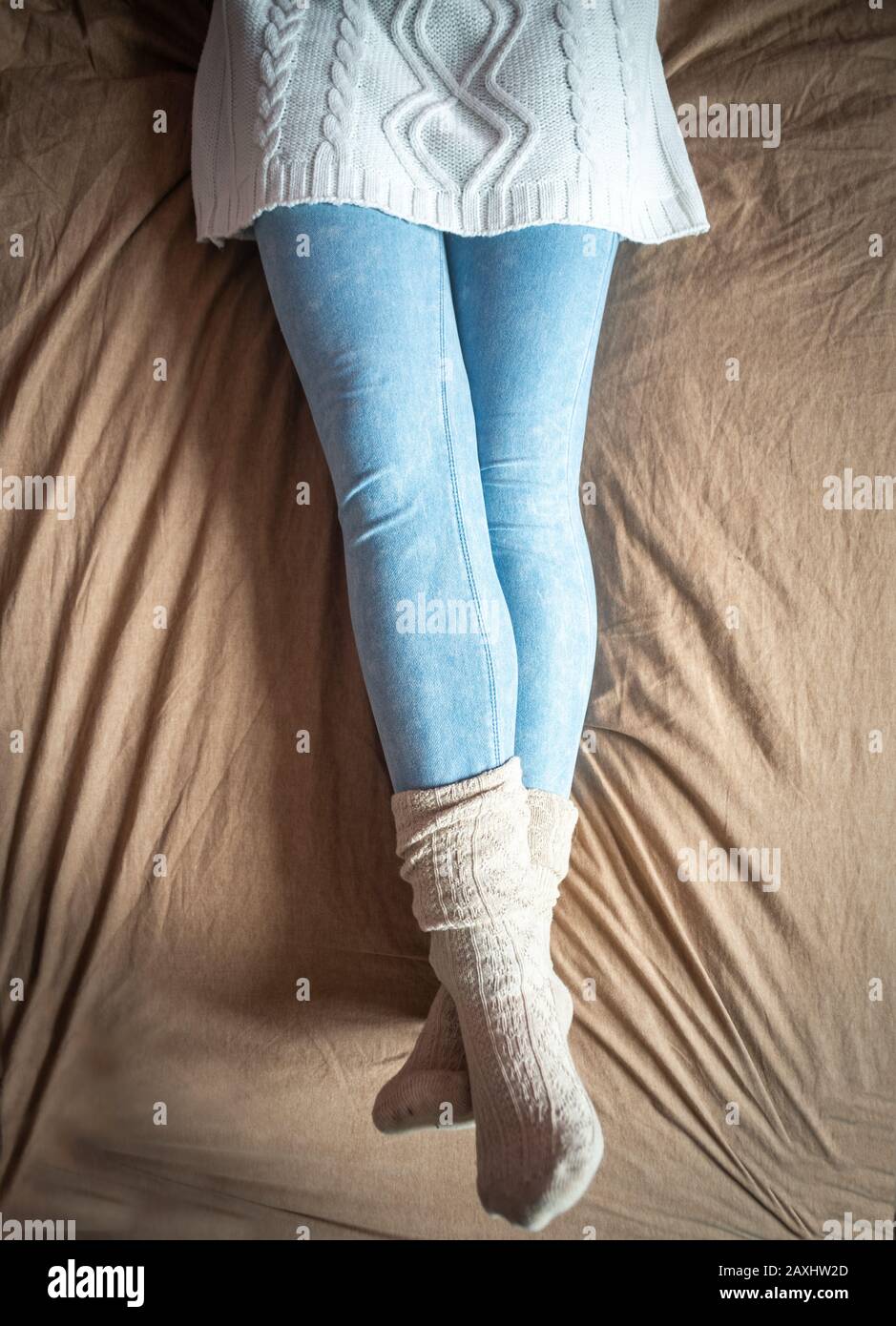 bed,wearing sweater, leggings \u0026 socks 