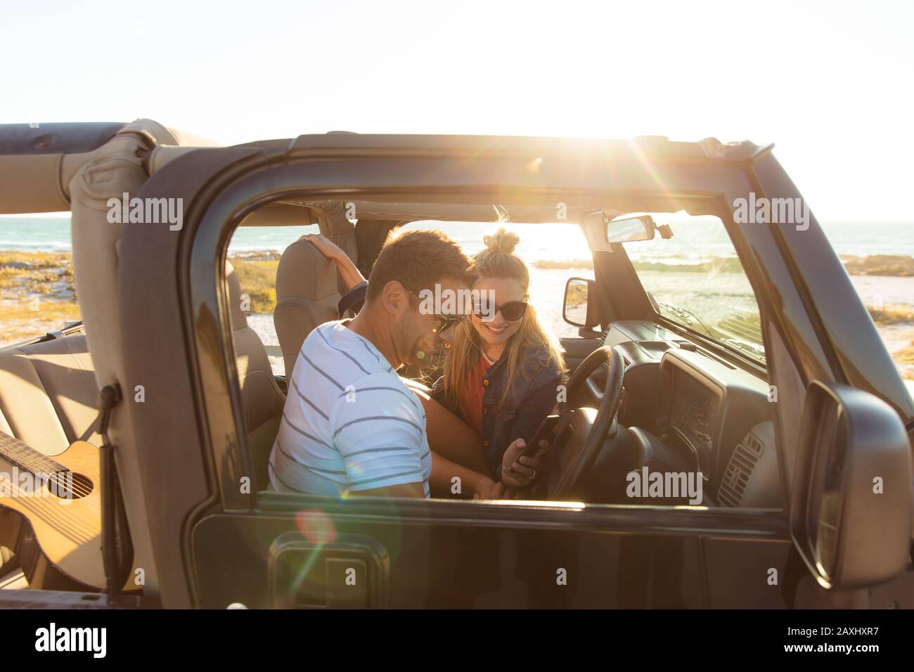 Couple in a car at the beach Stock Photo