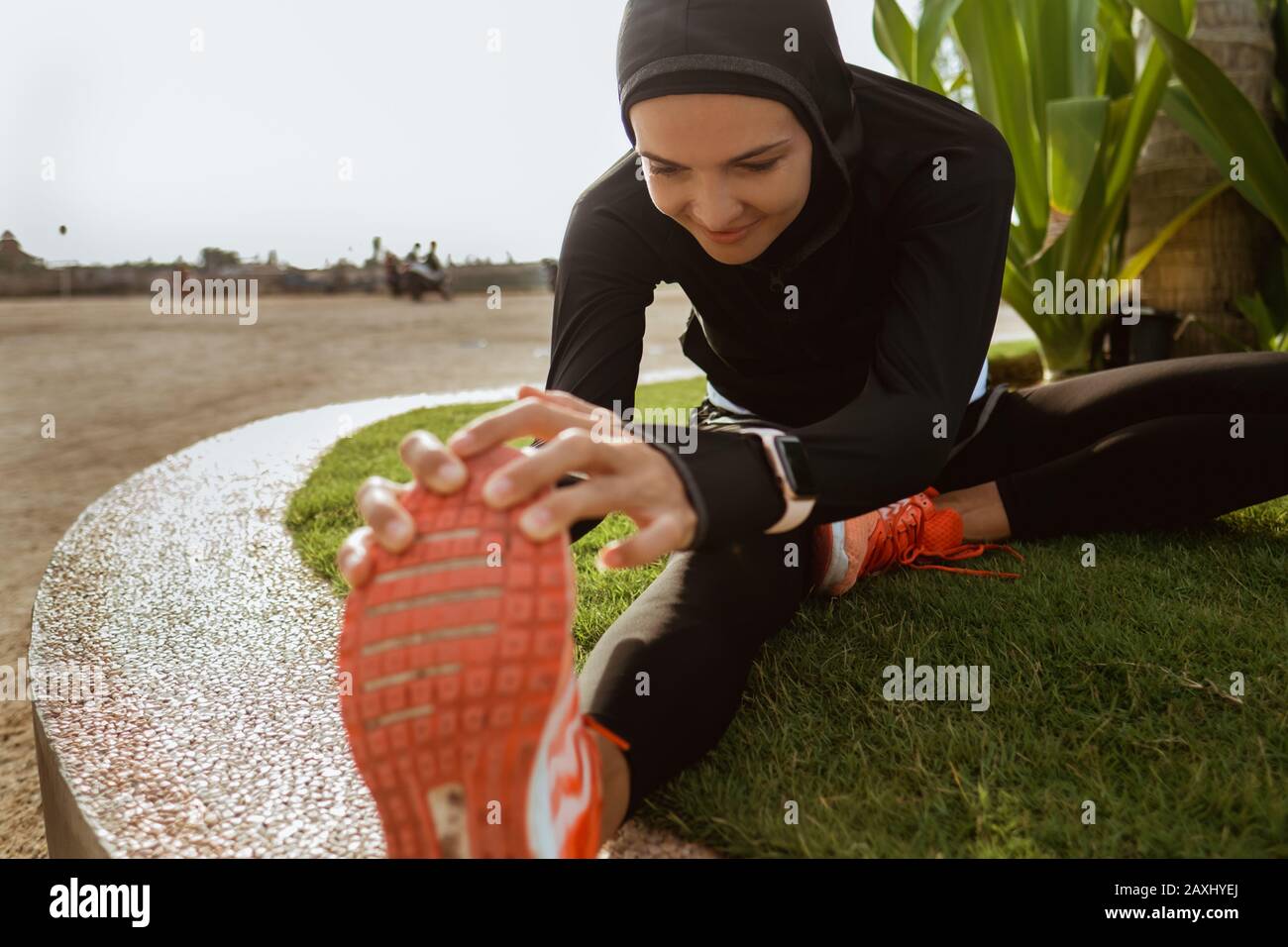 woman with muslim sport wear stretching. sporty female using head scarf