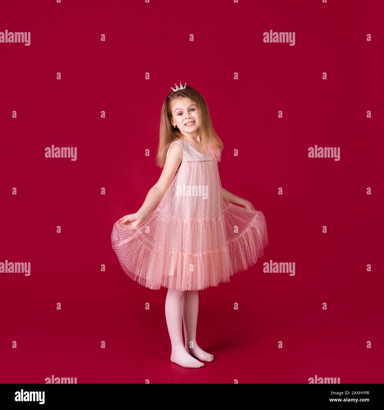 Beautiful little girl princess dancing in luxury pink and silver dress ...