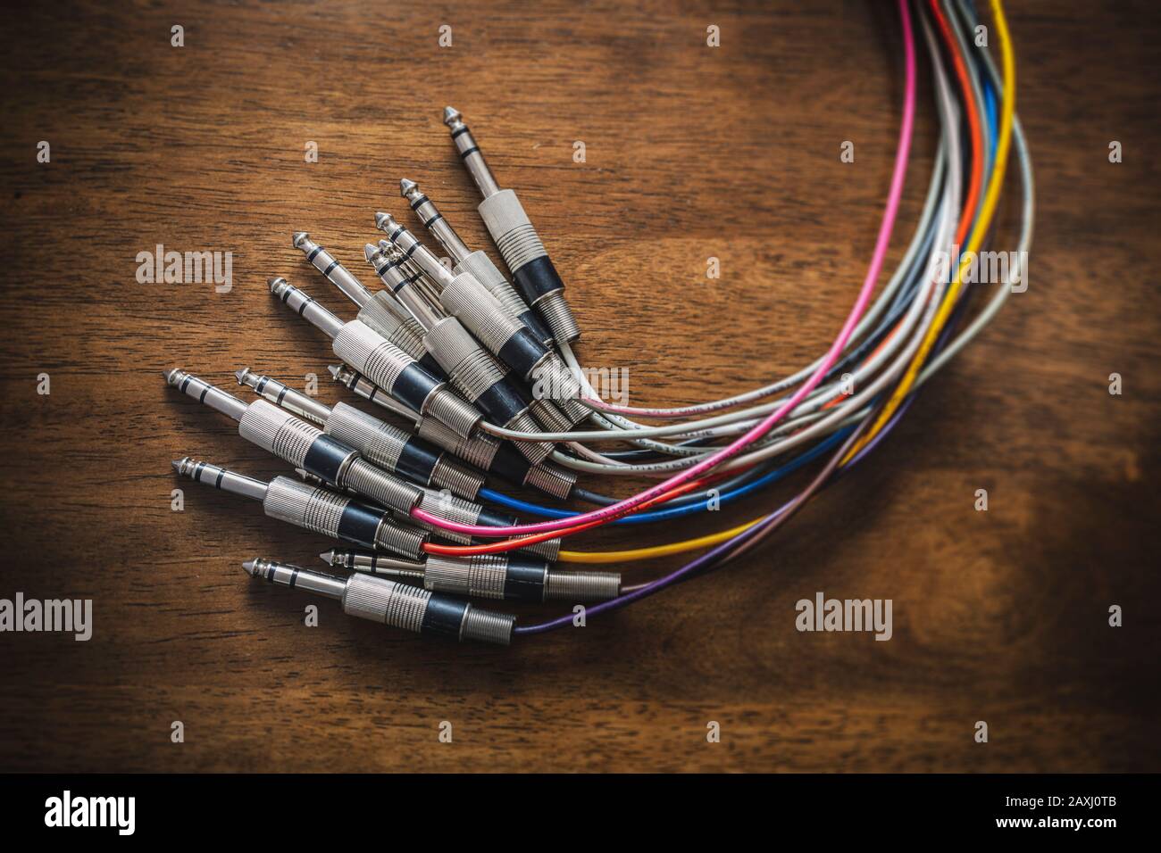 Bundle of audio jack plugs with colourful cables with a focus vignette Stock Photo