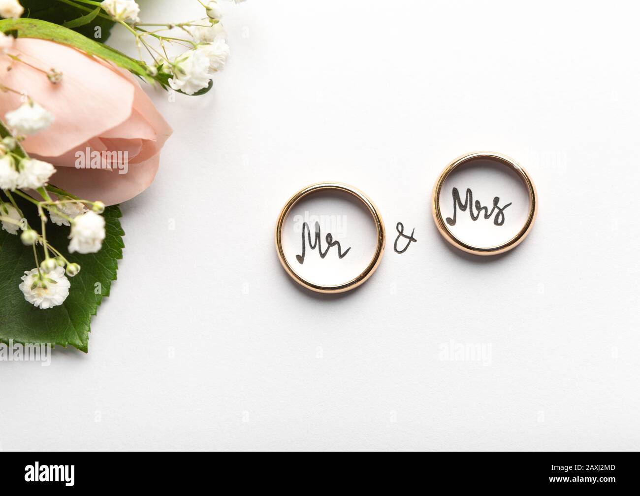 Engagement rings with text inside on background with cream roses Stock ...