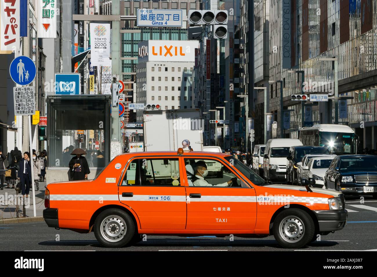 A bright orange Japanese taxi cab in Ginza, Tokyo, Japan A bright orange Japanese taxi cab in Ginza, Tokyo, Japan