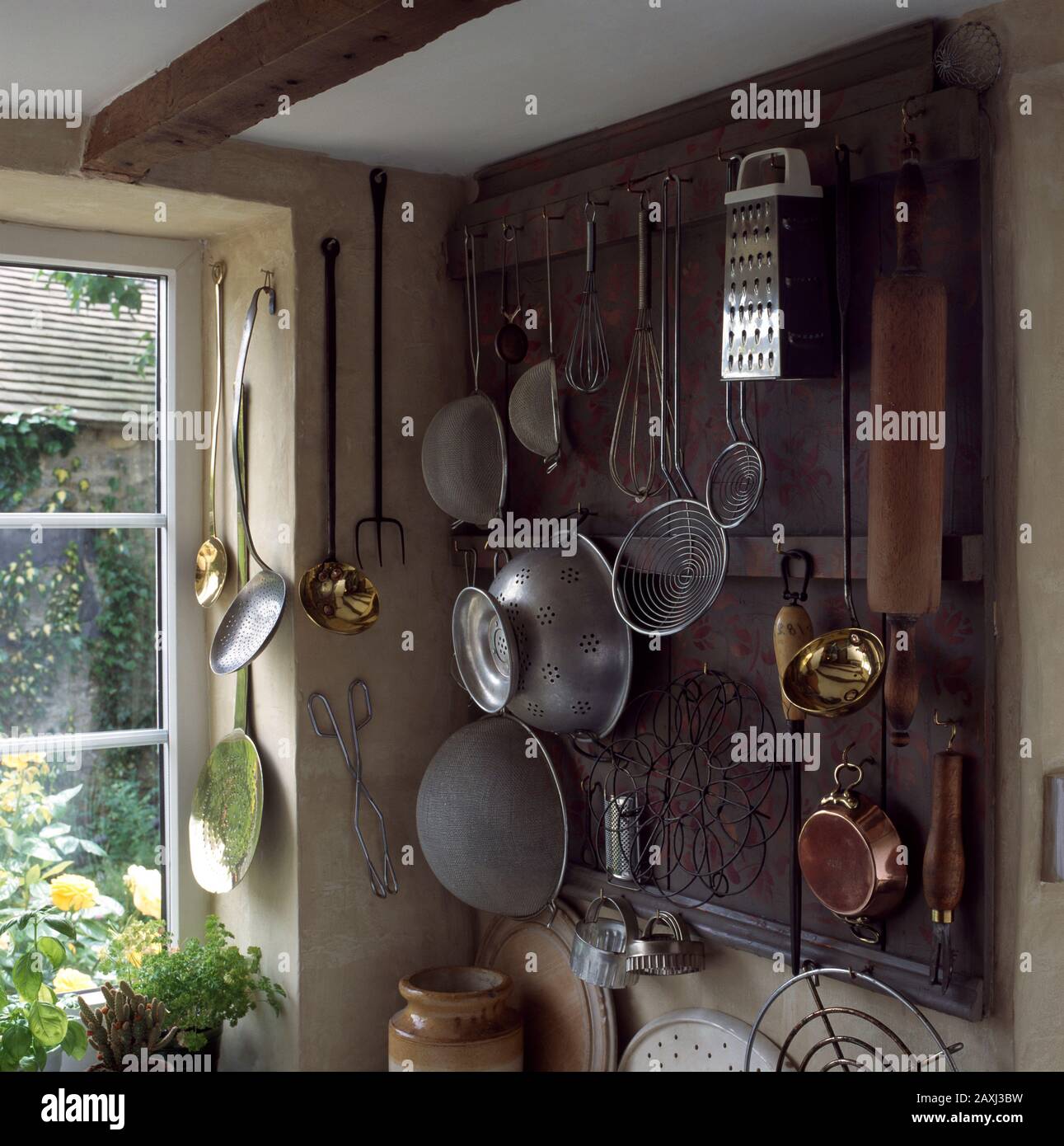 Kitchen utensils hanging on wall Stock Photo Alamy