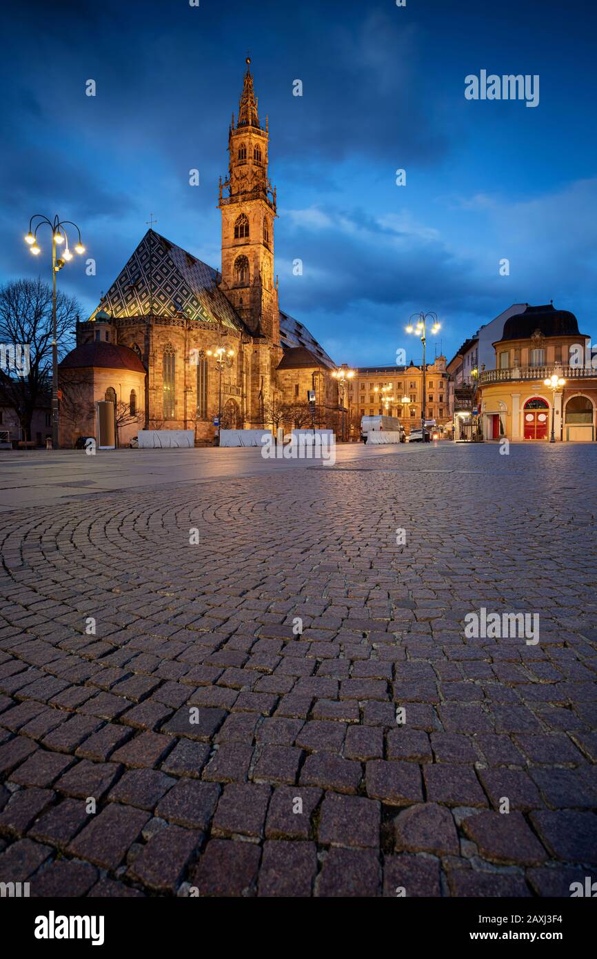 Bolzano, Italy. Cityscape image of historical city of Bolzano, Trentino, Italy with Bolzano Cathedral and the Walther Square during twilight blue hour Stock Photo