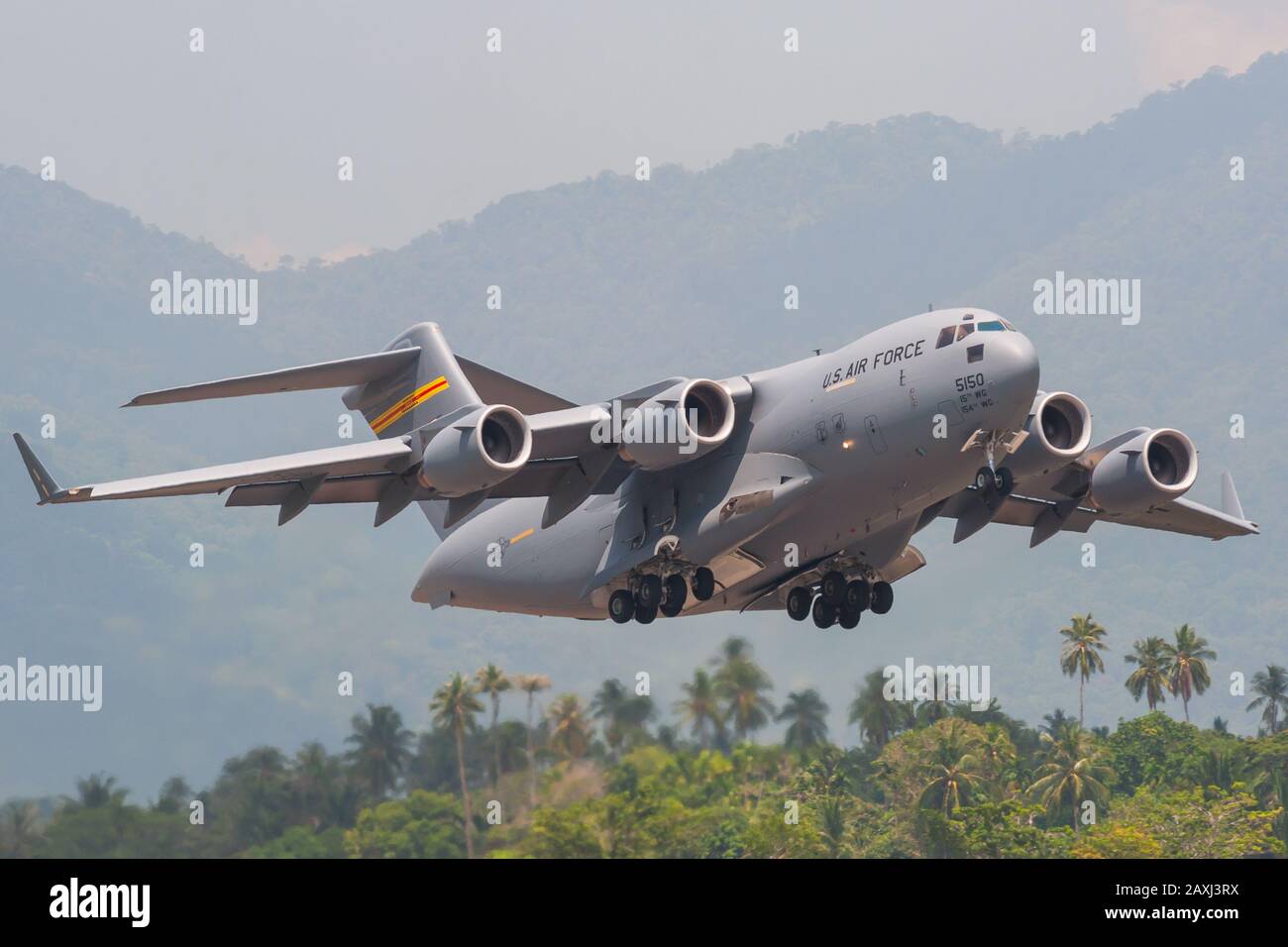 Boeing C-17A Globemaster III of the 15th Wing's 535th Airlift Squadron based at Hickam AFB, performs a tactical demonstration at LIMA 2013, Malaysia. Stock Photo