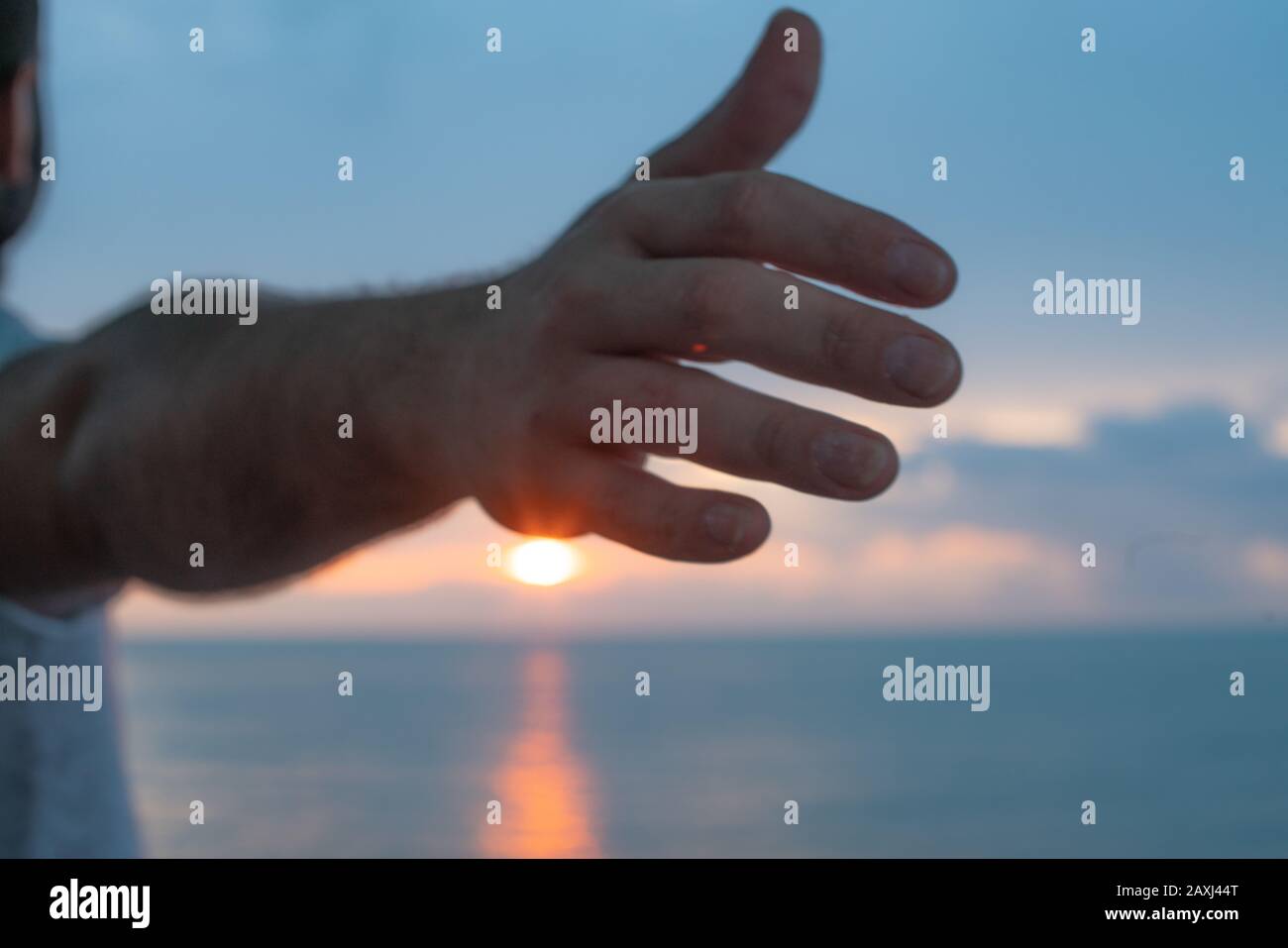 Hand that looks to the sea view. Freedom Concept. Stock Photo