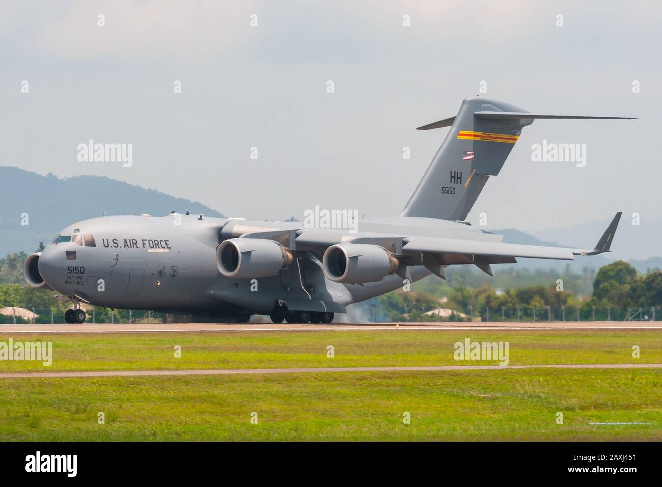 Boeing C-17A Globemaster III of the 15th Wing's 535th Airlift Squadron based at Hickam AFB, performs a tactical demonstration at LIMA 2013, Malaysia. Stock Photo