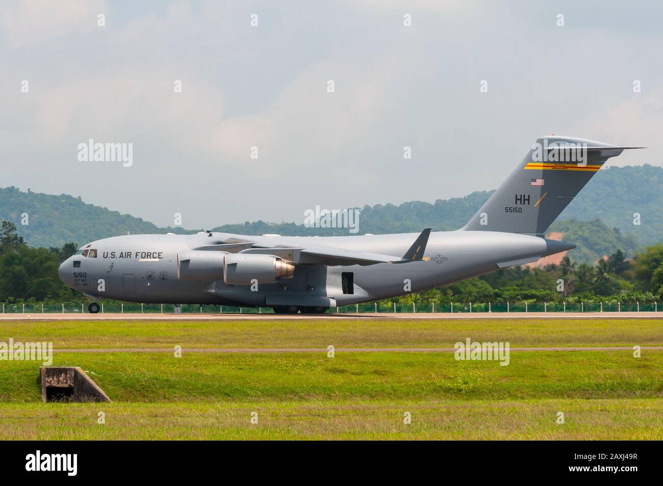 Boeing C-17A Globemaster III of the 15th Wing's 535th Airlift Squadron based at Hickam AFB, performs a tactical demonstration at LIMA 2013, Malaysia. Stock Photo