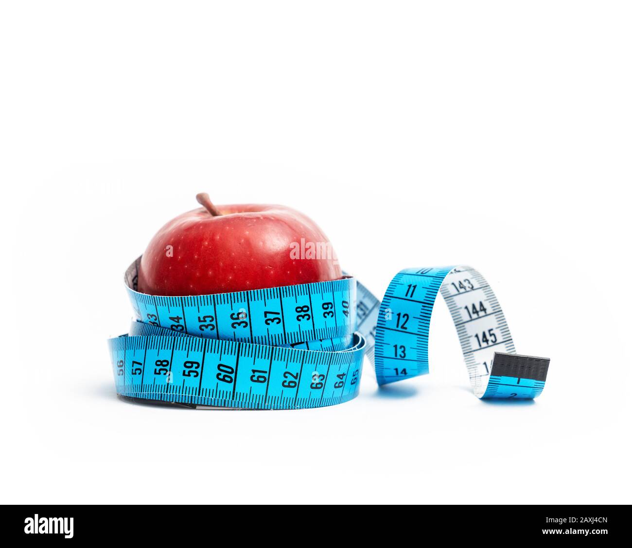isolated red apple wrapped with tape measuring on white background. Diet and healthy living concept Stock Photo