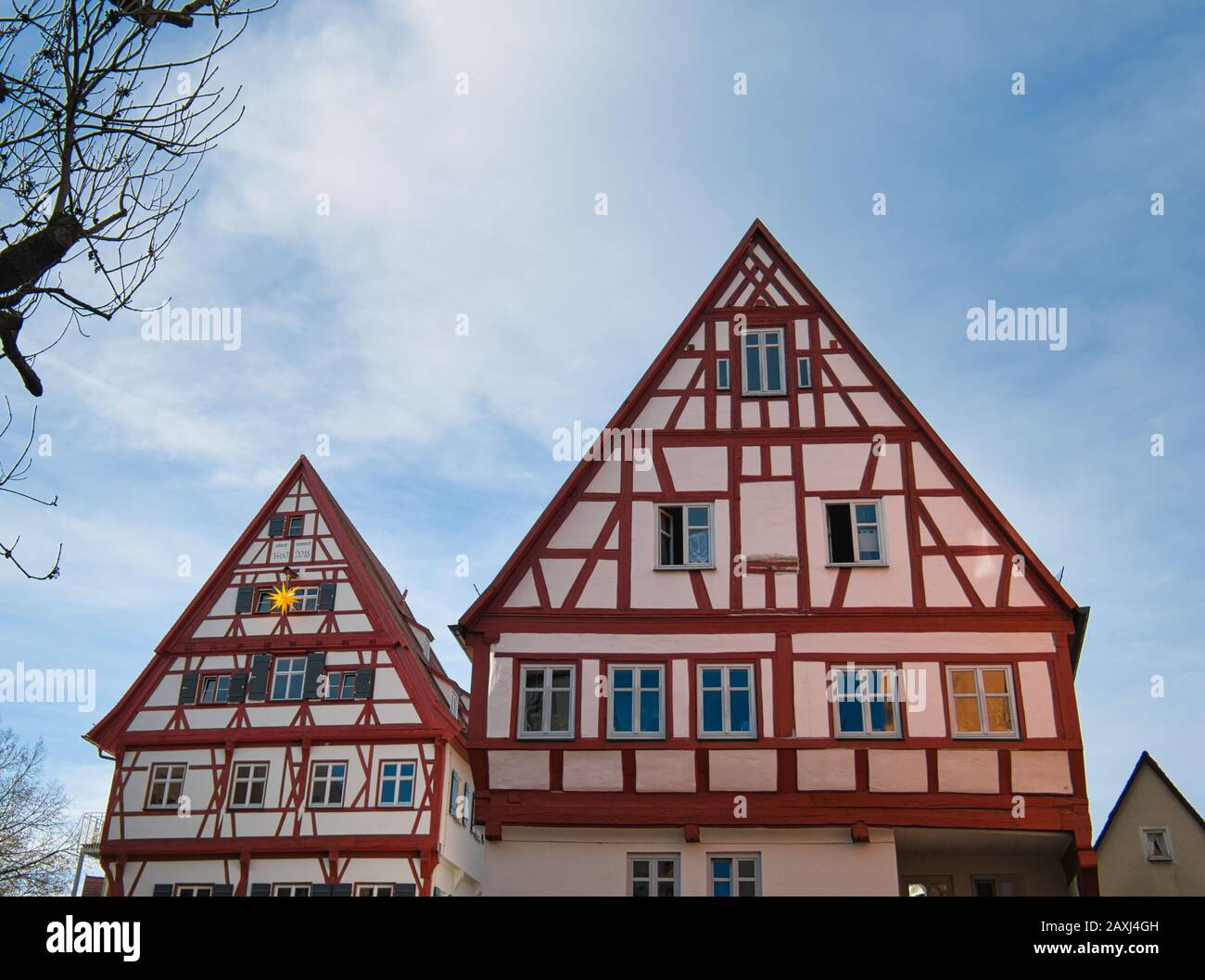 Two beautiful and very well preserved half-timbered houses with red wooden beams Stock Photo