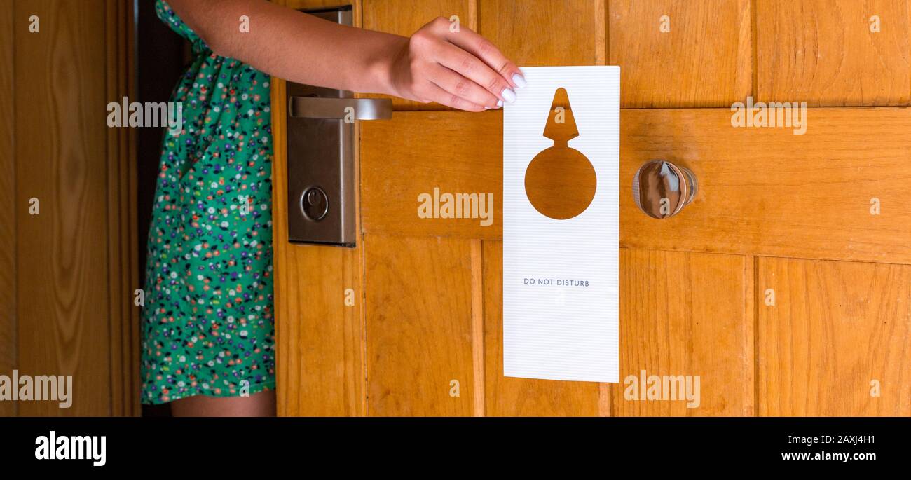 female-hand-hangs-a-sign-on-the-door-do-not-disturb-in-hotel-stock-photo-alamy