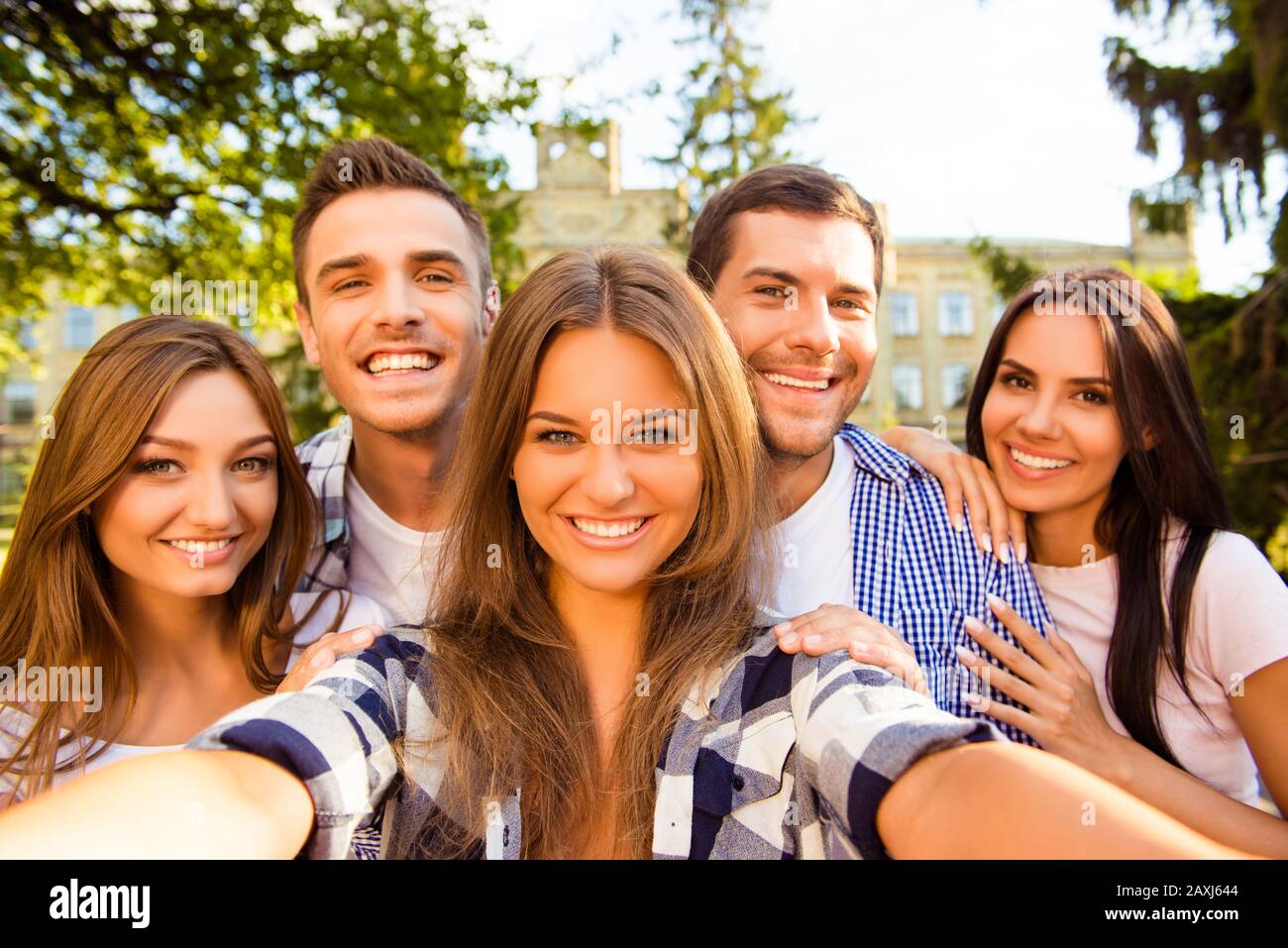 five cheerful best friends having fun and making selfie photo ...