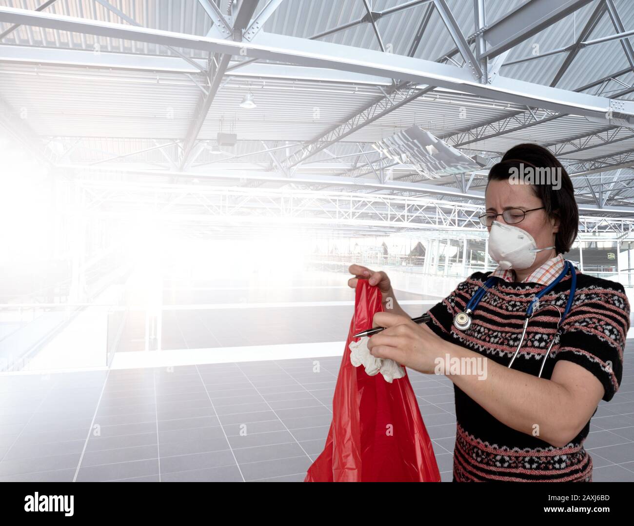 Woman with face breathing protection mask put paper waste into plastic bag.  Airport building Stock Photo - Alamy