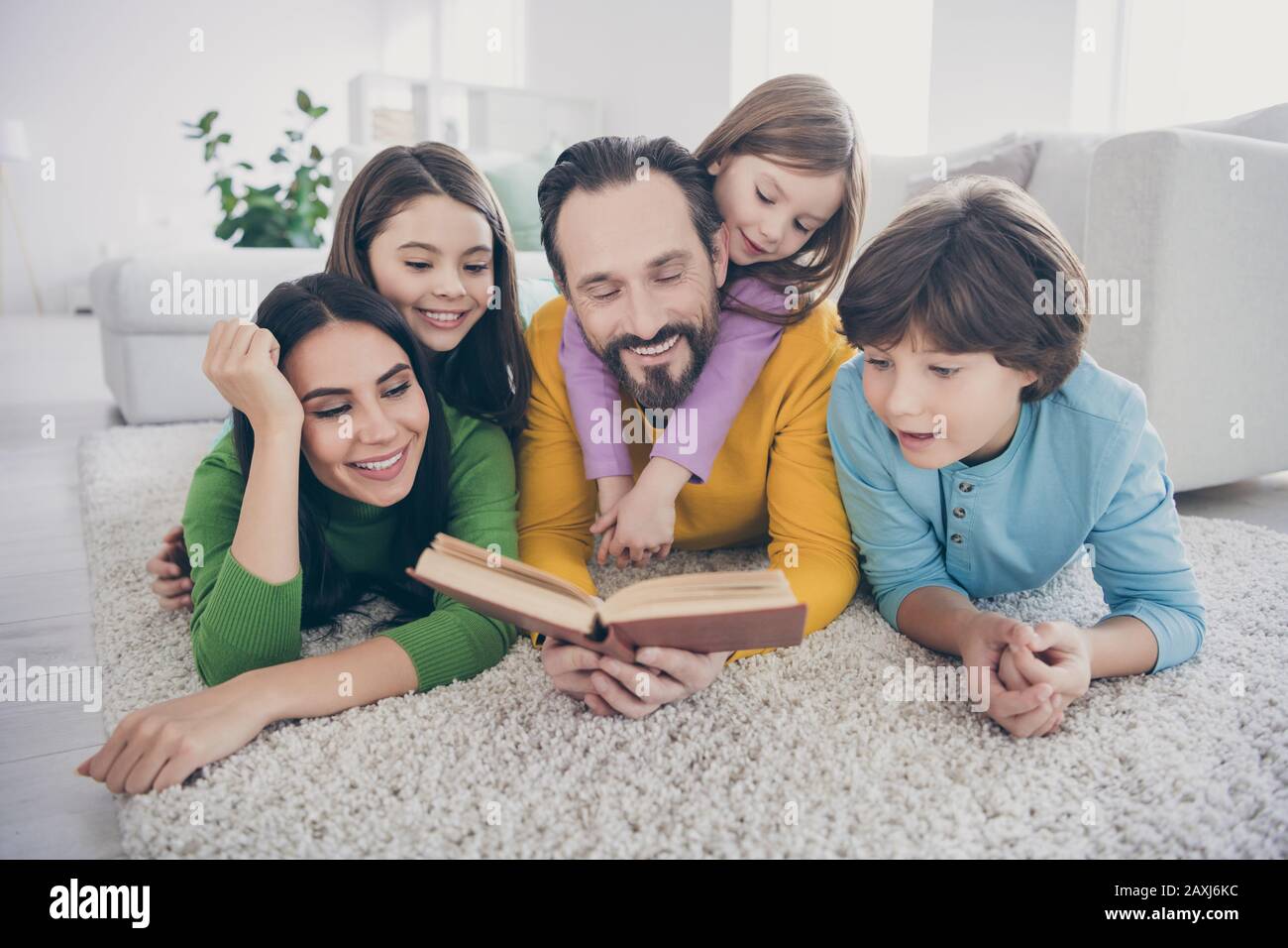 Cozy dreamy people enjoy free time lie carpet floor dad daddy read book