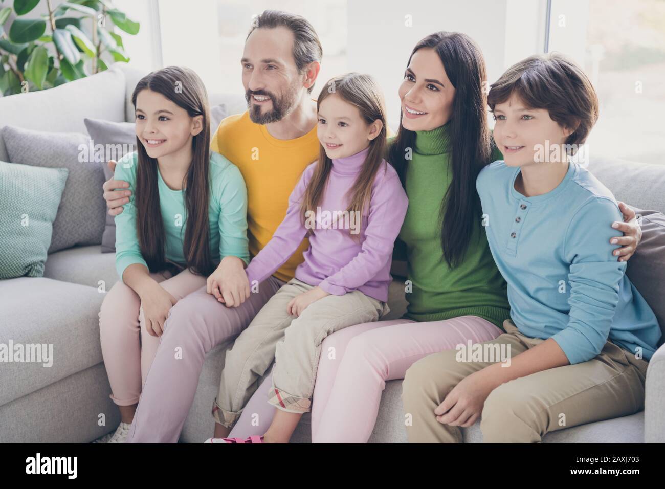 https://c8.alamy.com/comp/2AXJ703/loving-dream-harmony-cozy-family-five-people-watch-tv-sit-couch-enjoy-cartoons-dad-mom-hug-her-preteen-younger-older-adopted-children-in-room-house-2AXJ703.jpg