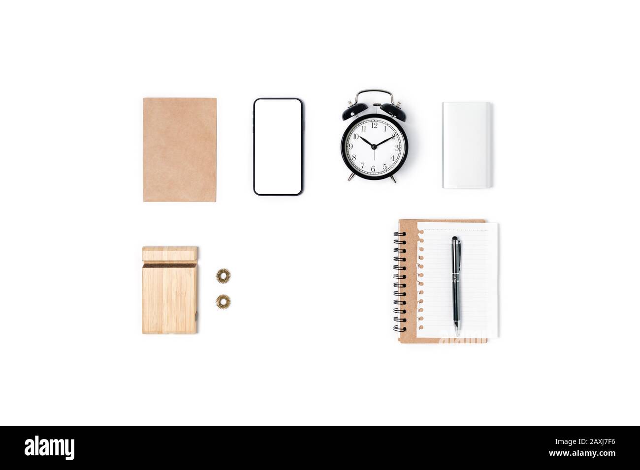 Modern workspace with smartphone, notepad, pen, alarm clock, phone holder and powerbank. Flat lay, top view, copy space. Stock Photo