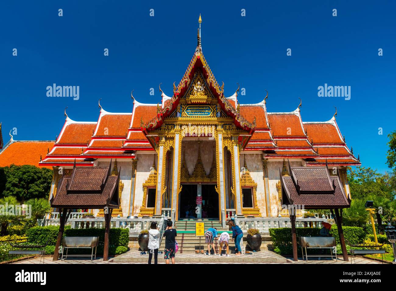 Wat Chalong,Phuket/Thailand-15December2019: view on a pagoda at the historical landmark and Buddhist temple with blue sky and sunny day Stock Photo