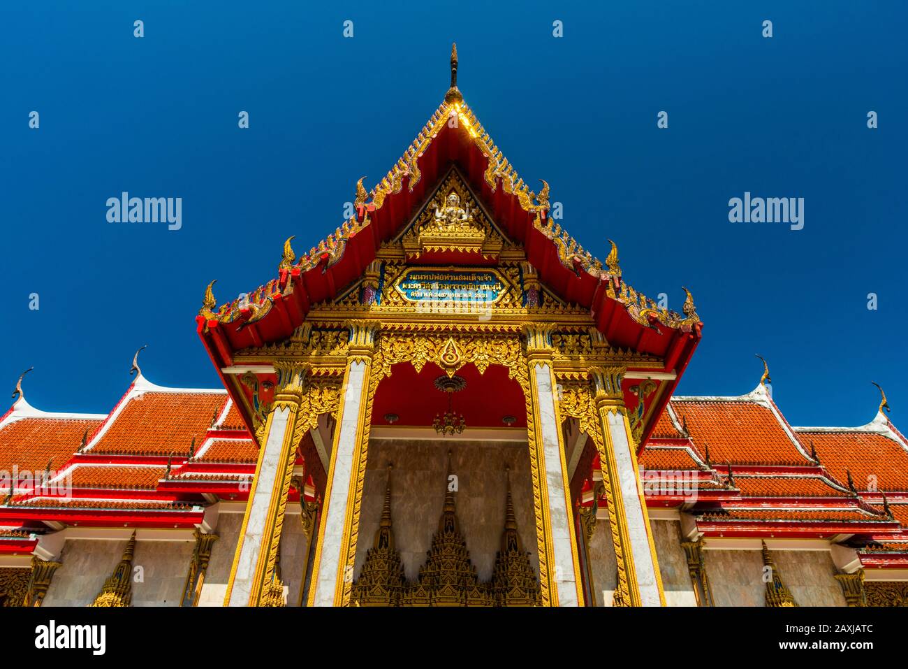 Wat Chalong,Phuket/Thailand-15December2019: view on a pagoda at the historical landmark and Buddhist temple with blue sky and sunny day Stock Photo