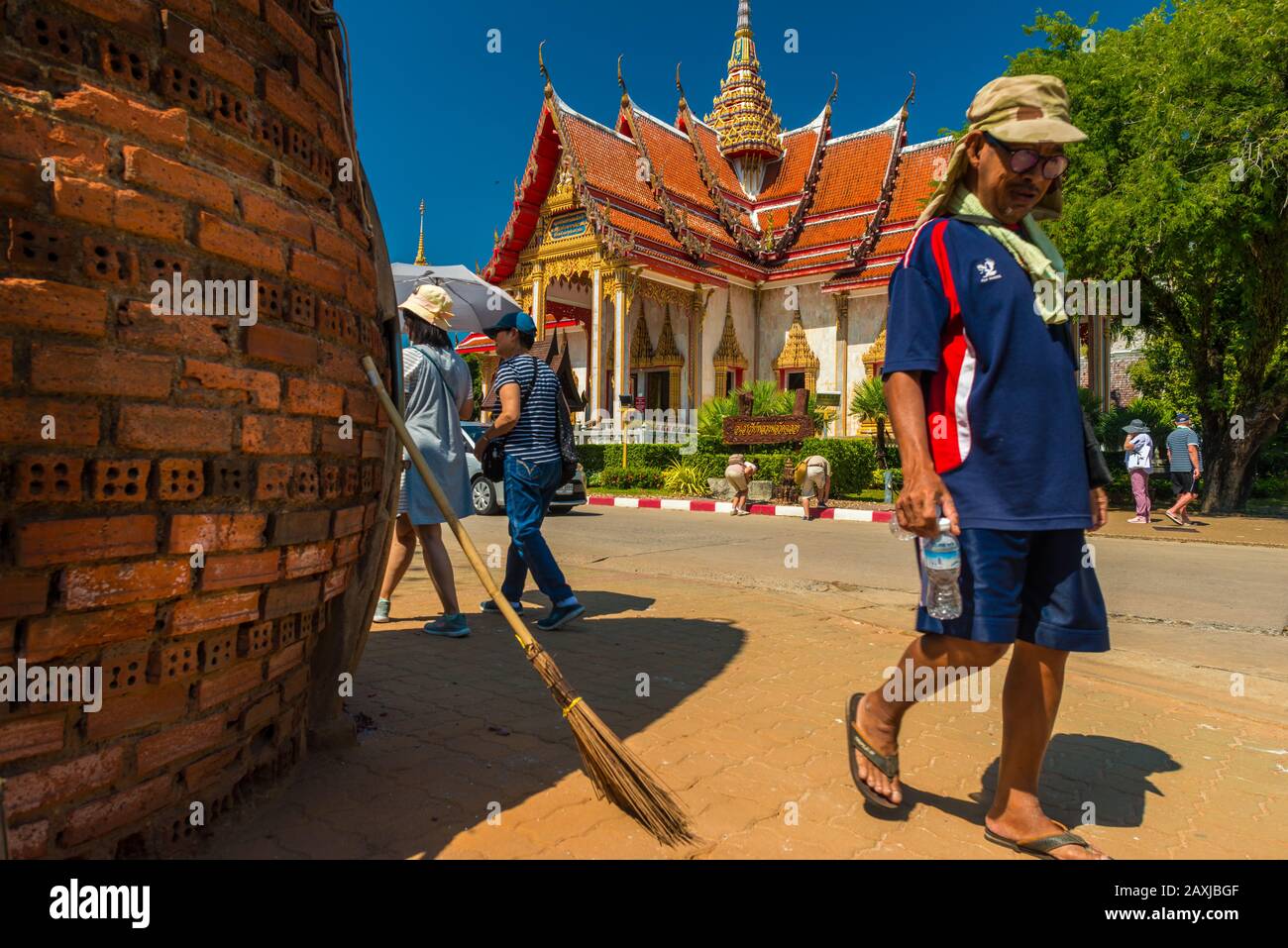 Wat Chalong,Phuket/Thailand-15December2019: view on a pagoda at the historical landmark and Buddhist temple with blue sky and sunny day with people wa Stock Photo