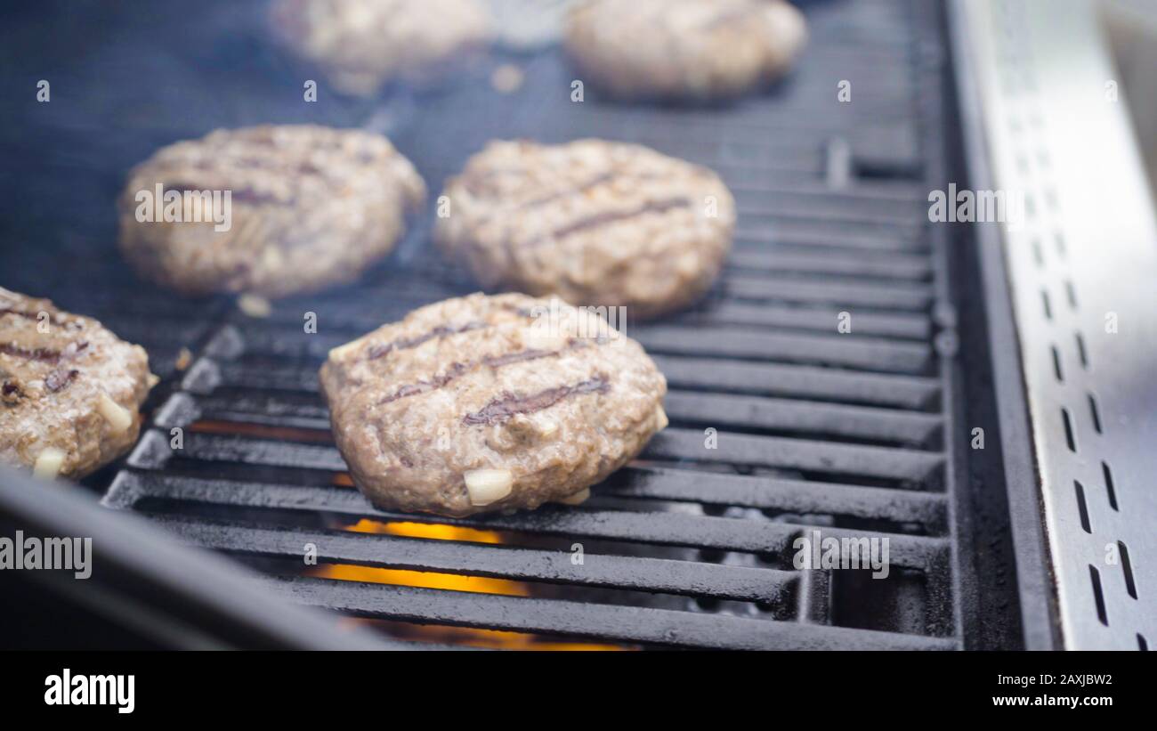 Cooking hamburger beef patties on a gas grill Stock Photo Alamy