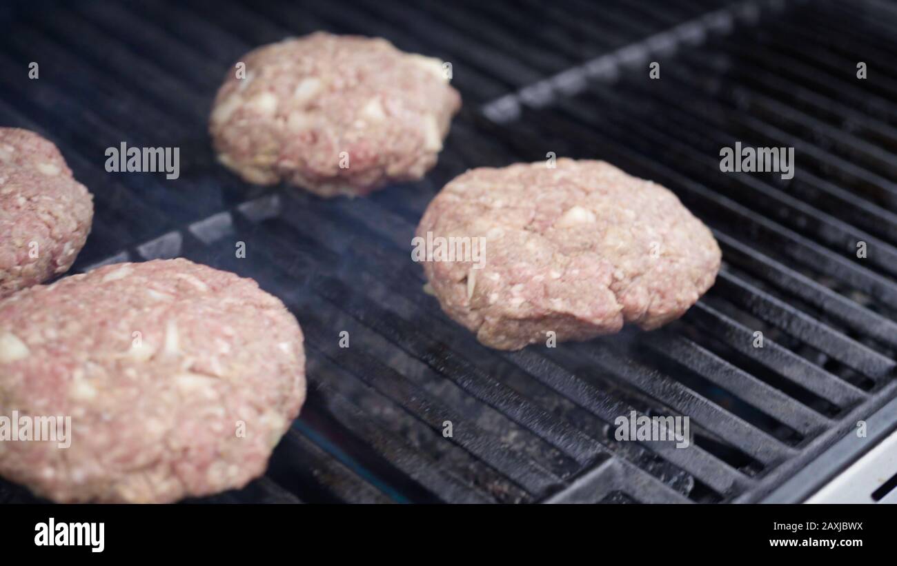 Cooking hamburger beef patties on a gas grill Stock Photo Alamy