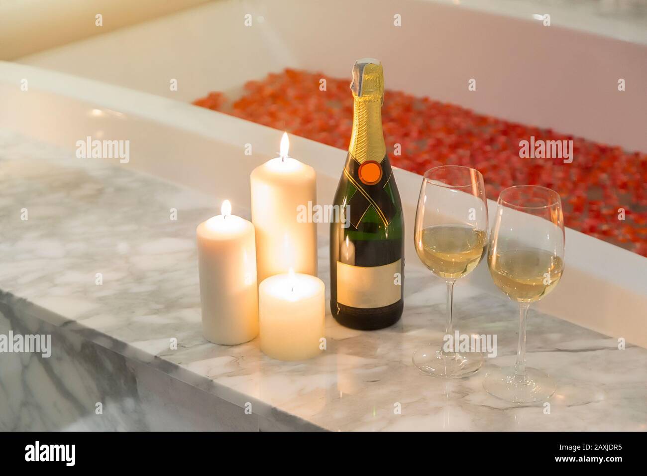 Two glasses of champagne with candle near jacuzzi. Valentines background. Romance concept. Stock Photo