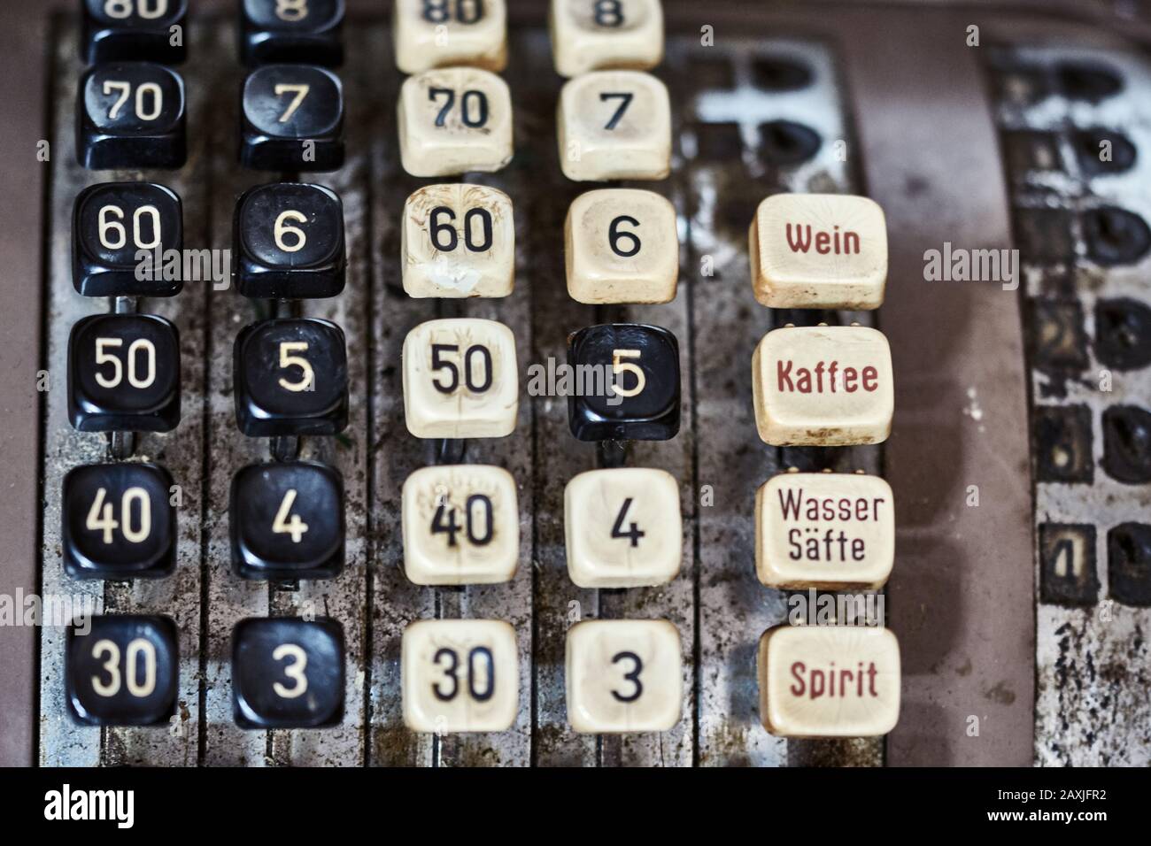 Close-up of a vintage cash register.  Brown and ancient restaurant till with many dirty, yellowed buttons. Stock Photo