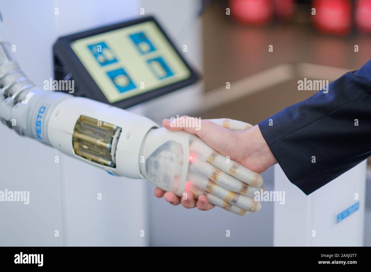 Hannover, Germany. 12th Feb, 2020. An employee of the Festo company shakes the pneumatically operated robot hand 'Bionic Soft Hand' of the Festo company before the start of a press conference at the Hanover Fair on the subject of digital change in industry. Photo: Ole Spata/dpa Credit: dpa picture alliance/Alamy Live News Stock Photo