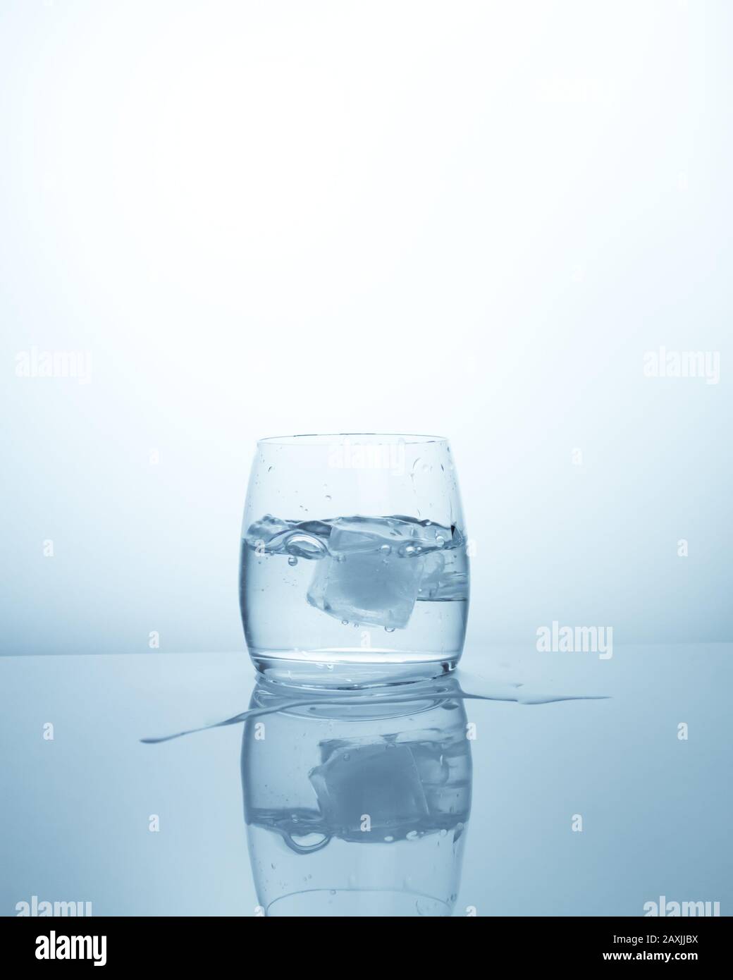 A glass with clean fresh purified water with an ice cube. Cool ...