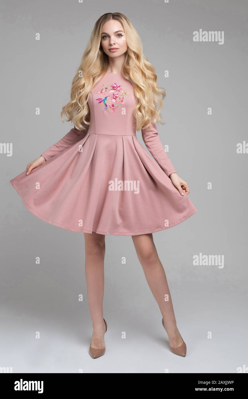 Beautiful young blonde model in pink dress Stock Photo - Alamy
