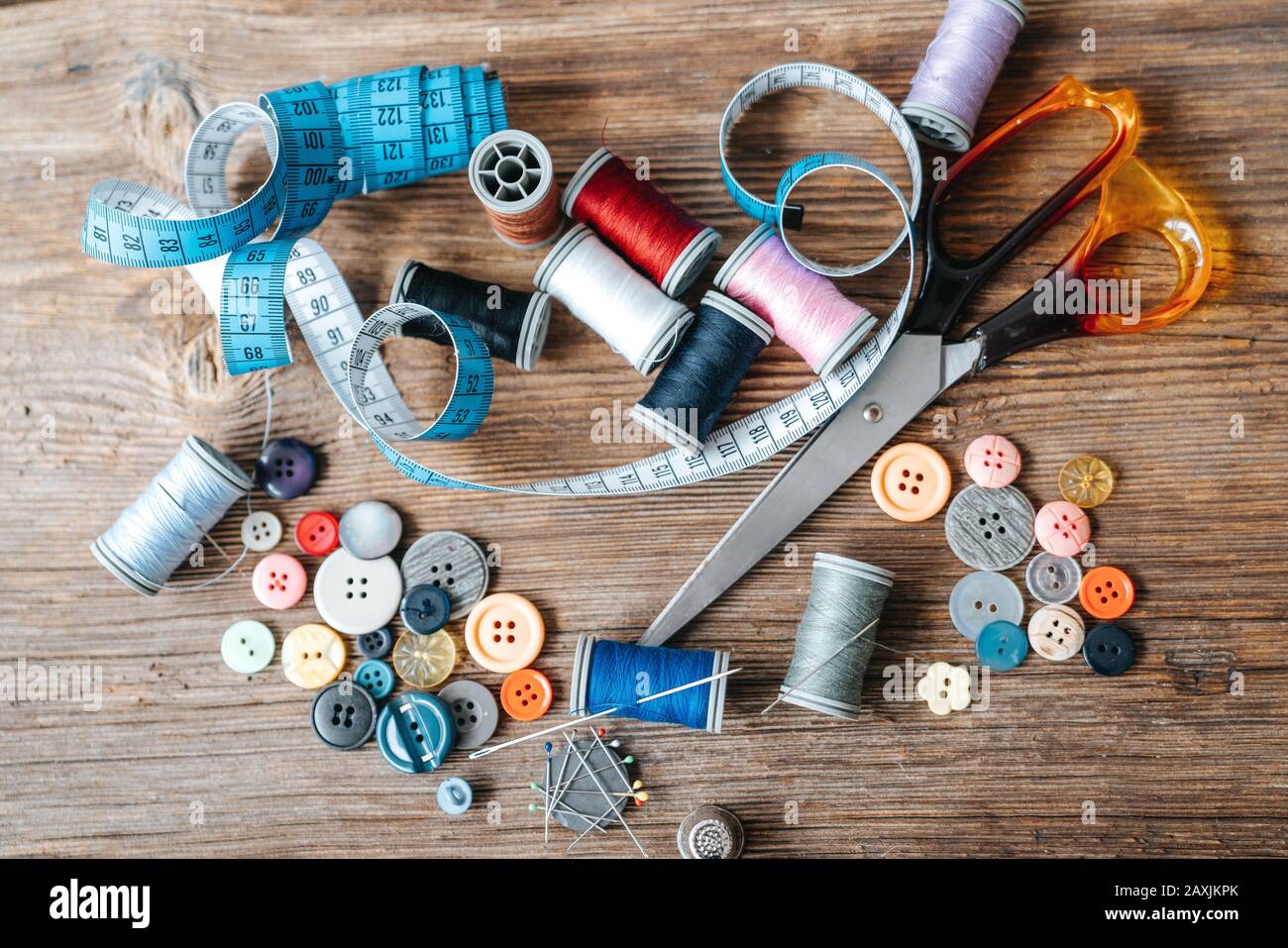 Top view of objects about Sewing equipment set on a wooden background. Sewing and tailoring concept Stock Photo