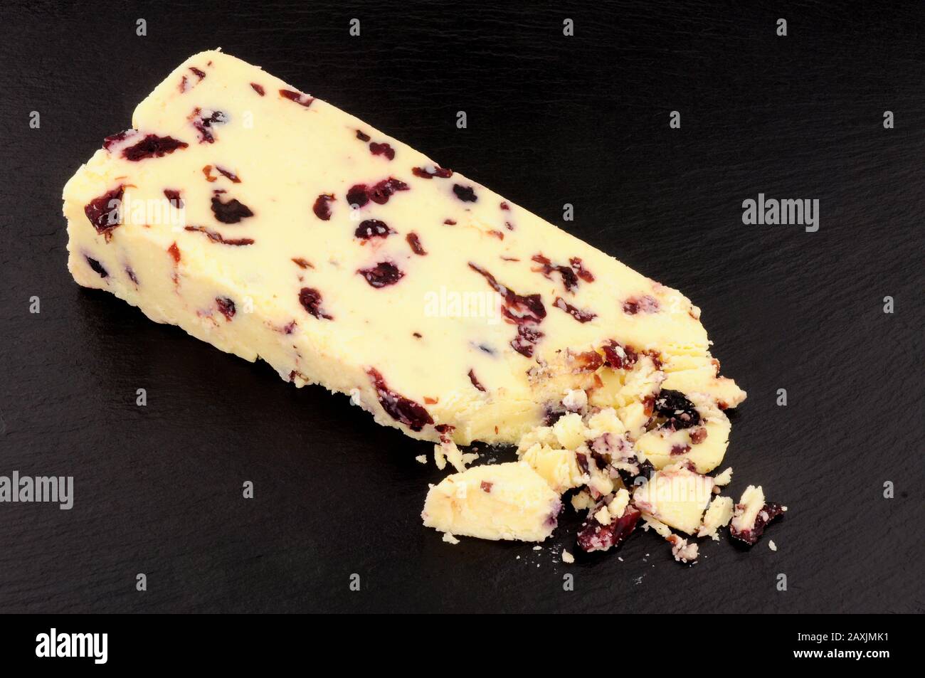 Wensleydale cheese with cranberries on a slate stone background Stock Photo