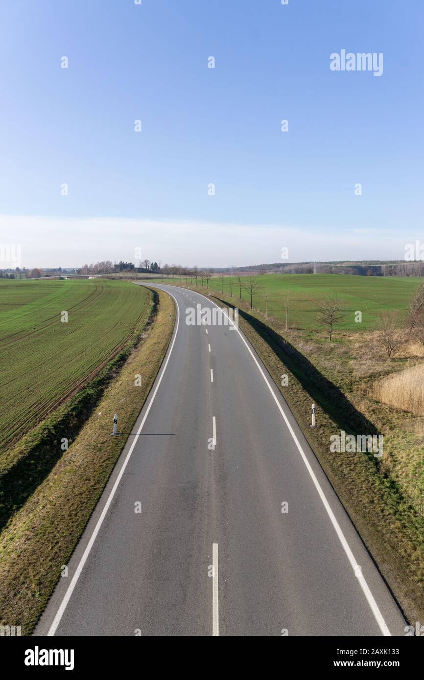empty asphalt road to the horizon, cloudless blue sky, in Germany near Dresden Stock Photo
