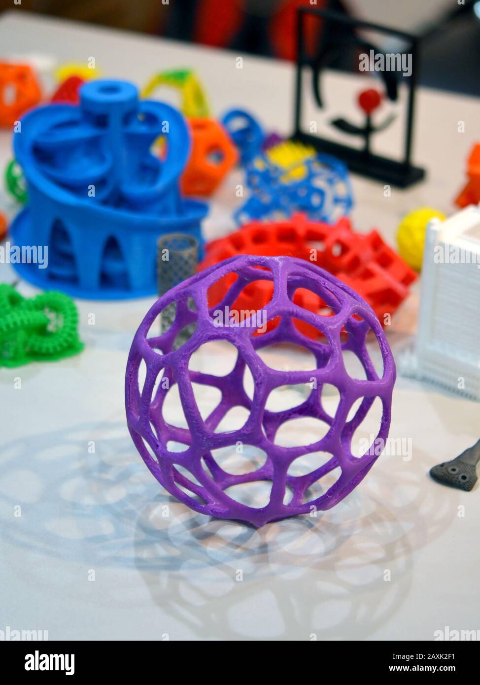 Objects printed by 3d printer. Bright colorful objects printed on a 3d printer on a table Stock Photo