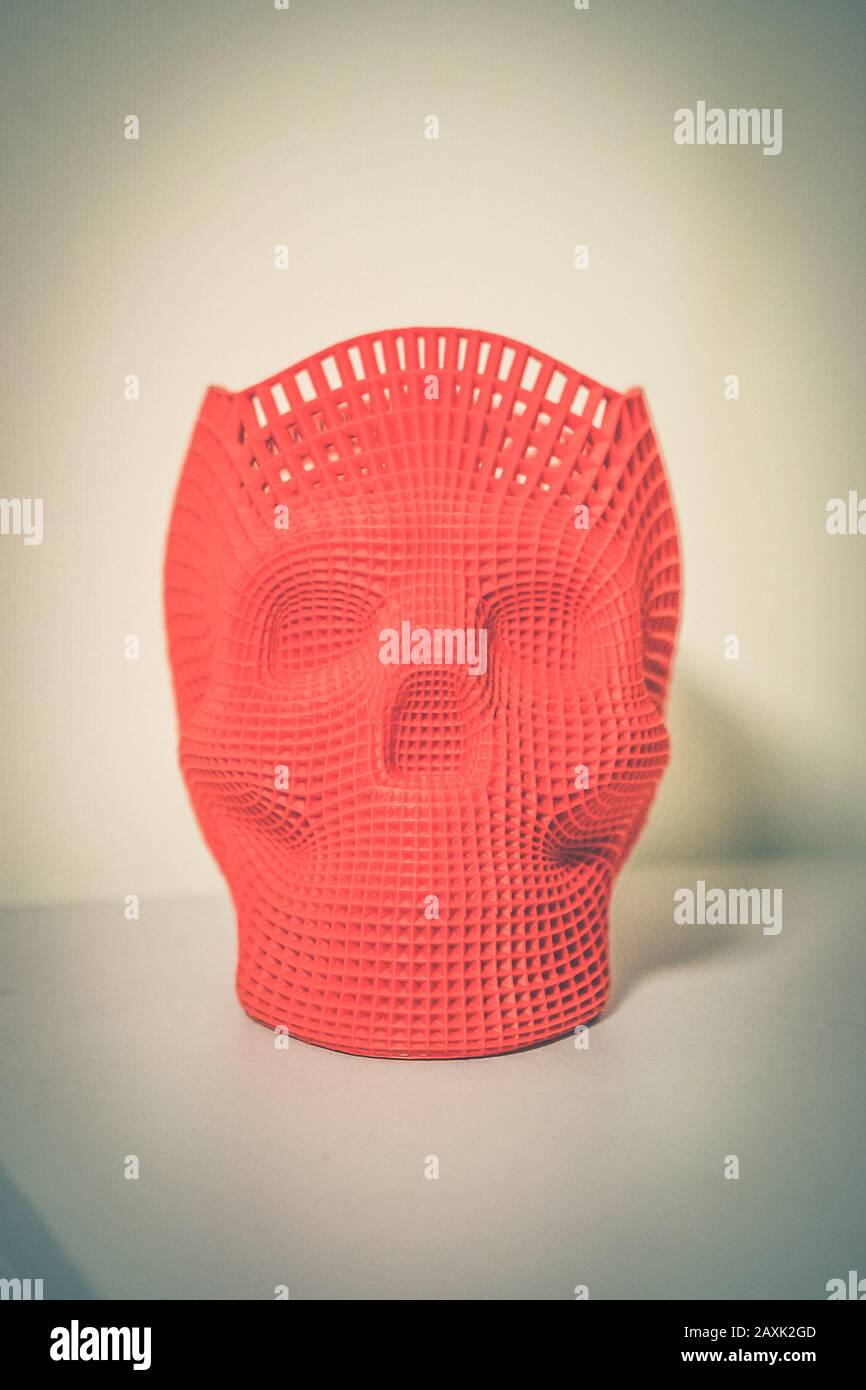 Skull printed with plastic of red color on a 3d printer. Stock Photo