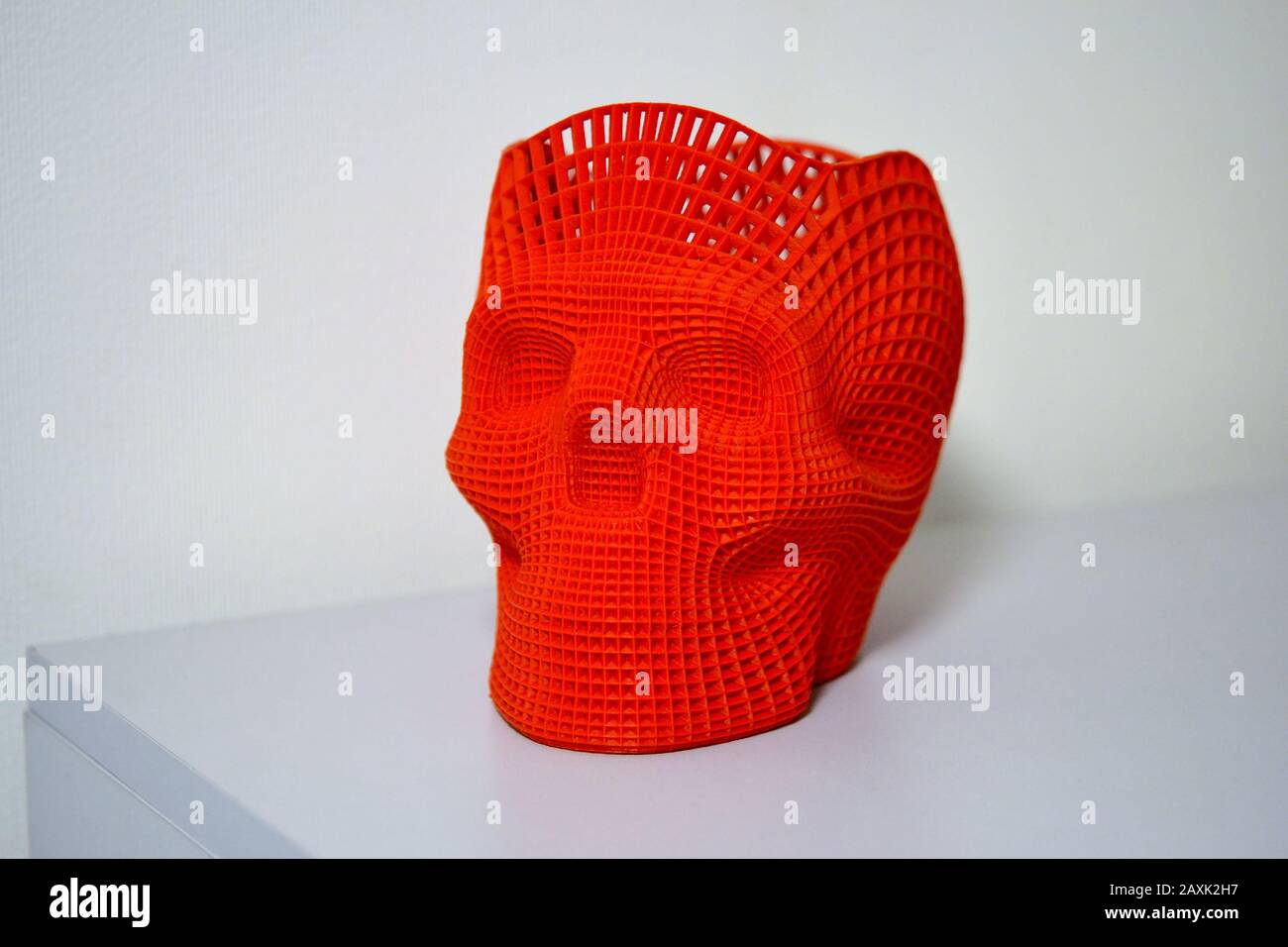 Skull printed with plastic of red color on a 3d printer. Stock Photo
