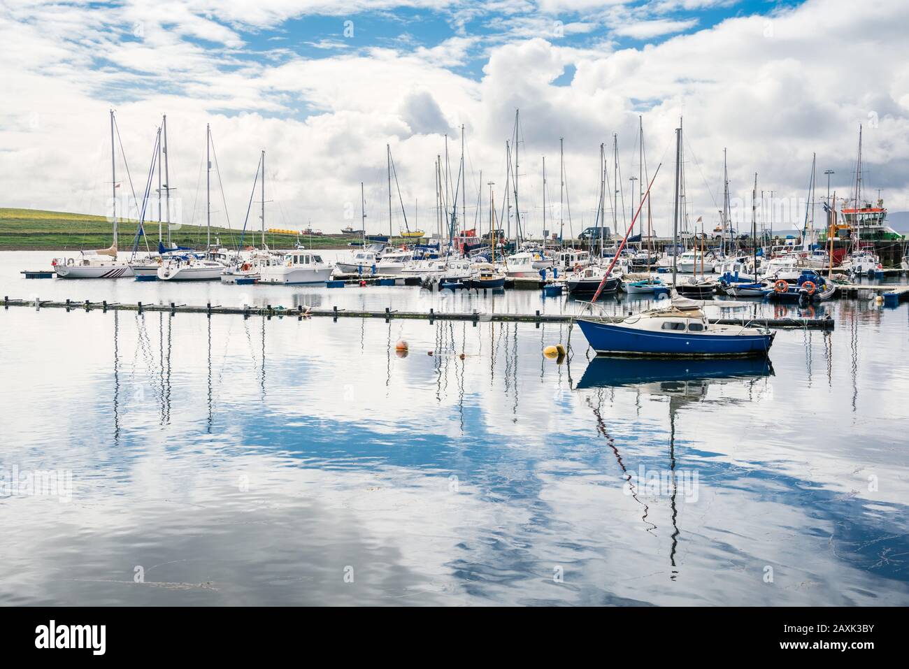 Yachts moored in a harbour on a partly cloudy summer day Stock Photo