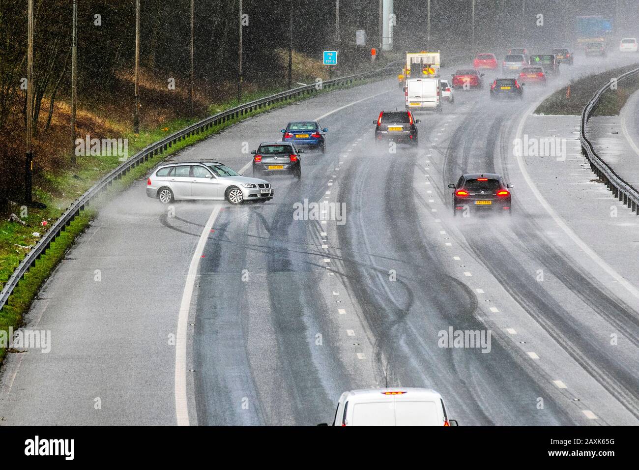 Chorley, Lancashire.  UK Weather. 12th Feb, 2020.  Motorist loses control of vehicle  and crashes on M6 motorway after heavy microburst hailstorm makes for difficult driving conditions. The lucky BMW driver ended up hitting the Armco Crash Barrier,  on the hard shoulder and finished facing oncoming traffic. Credit; MediaWorldImages/AlamyLiveNews Stock Photo