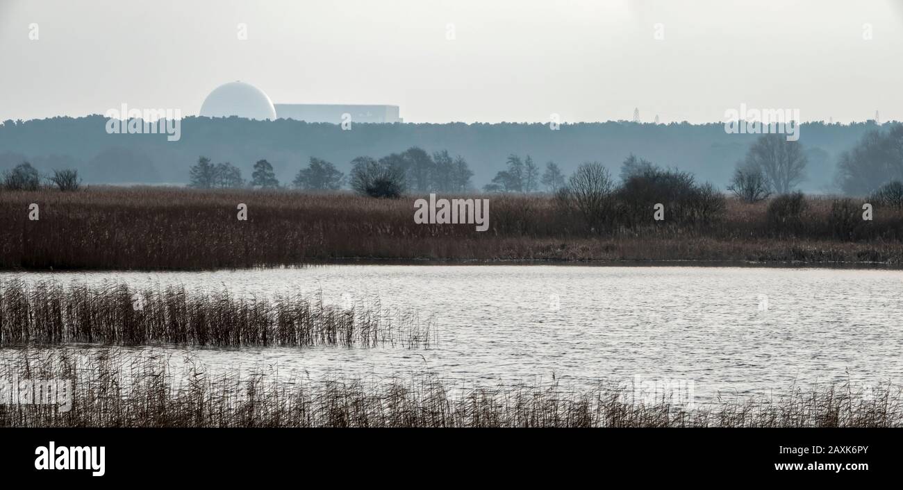 Sizewell B Nuclear Power Plant seen in the distance across water and reed bed at RSPB nature reserve Minsmere, Suffolk UK Stock Photo
