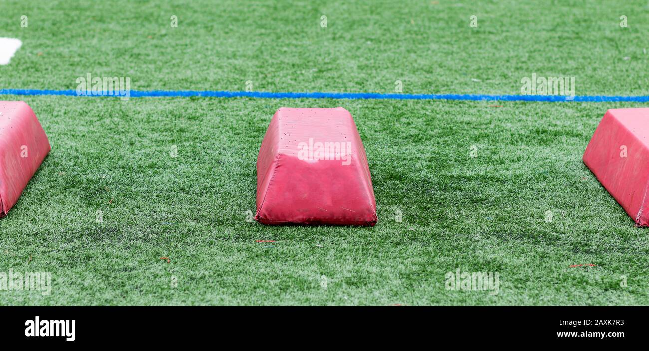 Three practice agility barriers used during football practice on a green turf field. Stock Photo