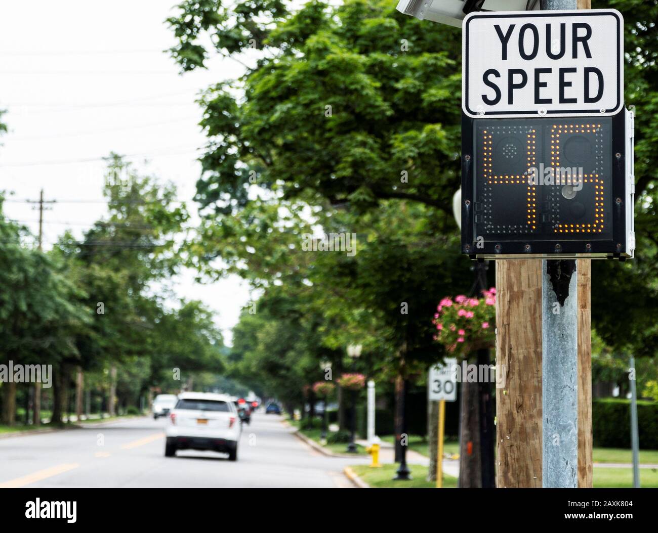 A radar gun is posting your driving speed on a sign as you enter Babylon Village. Stock Photo