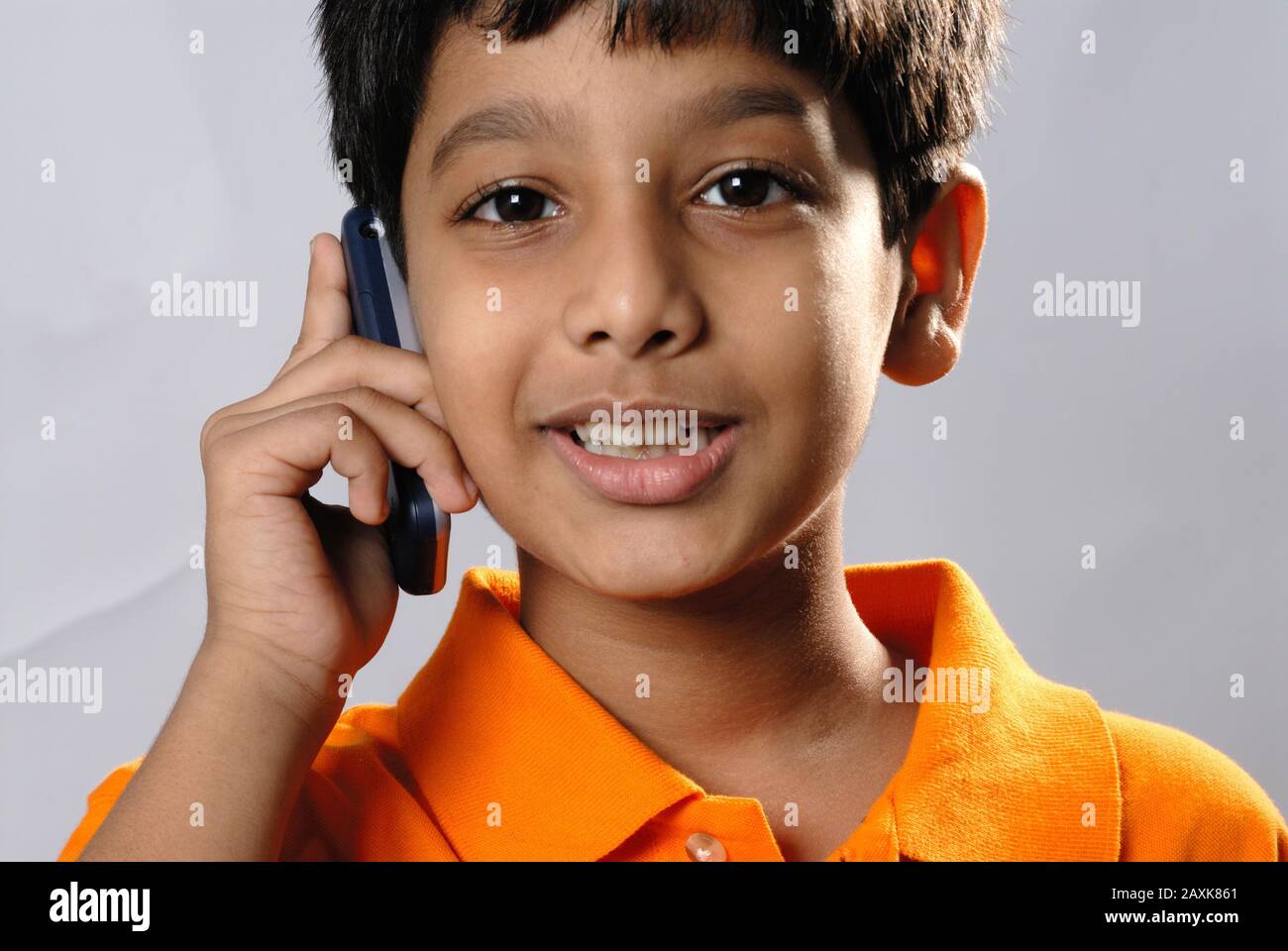 Mumbai, Maharashtra, India- Asia, Supt. 30, 2006 - Indian little cute  naughty boy funny expression talking on mobile phone Stock Photo - Alamy