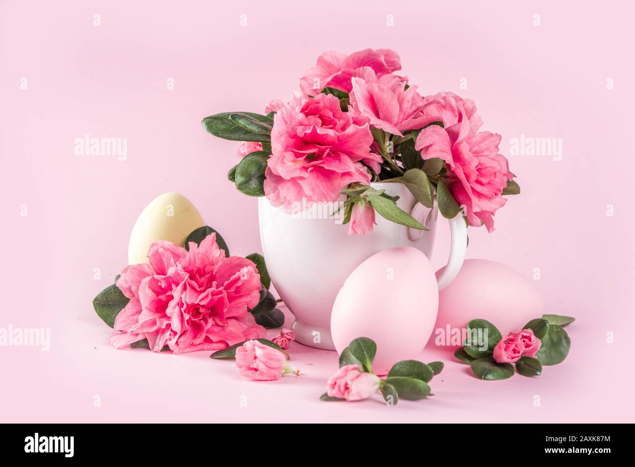 Tender Easter composition with easter eggs and pink spring flower