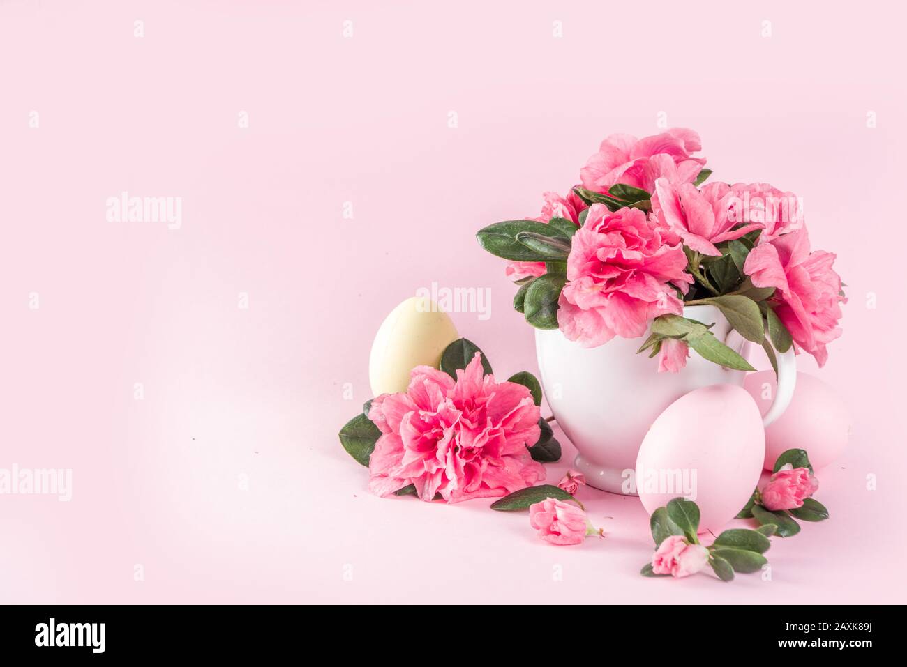 Tender Easter composition with easter eggs and pink spring flower