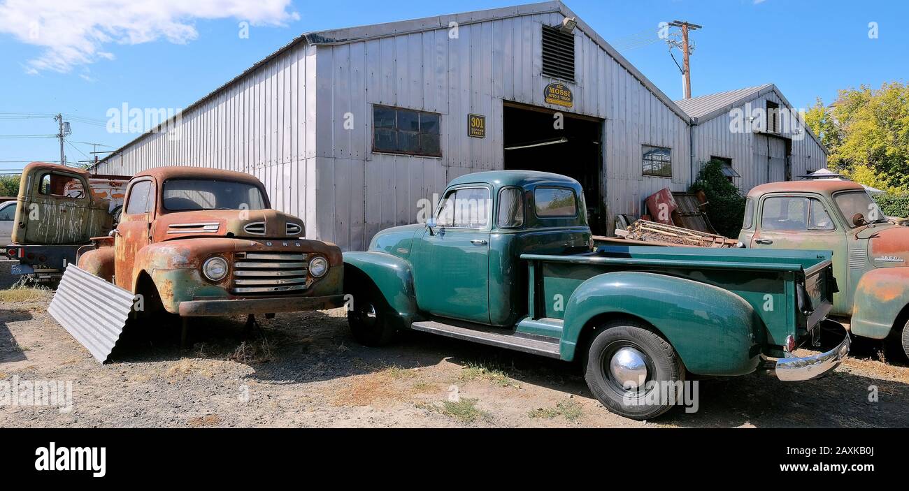 Old pickup trucks in front of a garage, Petaluma, California, USA Stock Photo